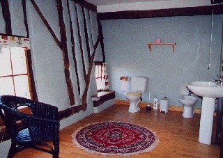 The huge wooden floored bathroom